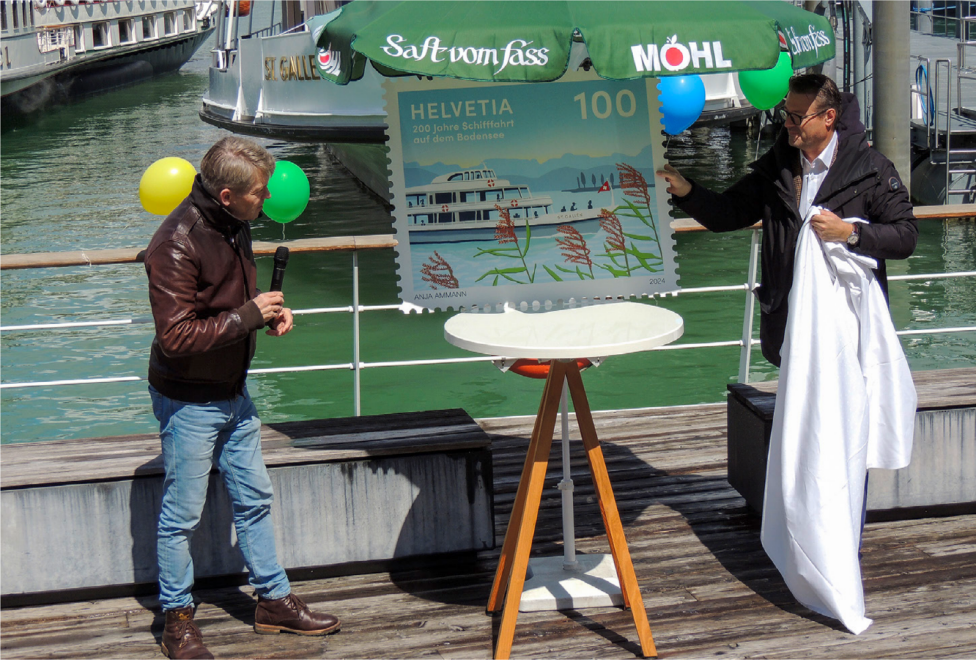 Benno Gmr (CEO Schweizer Bodensee-Schifffahrt AG, links) und Stadtprsident Roger Martin enthllen am Hafenfest gemeinsam die Sonderbriefmarke 200 Jahre Schifffahrt auf dem Bodensee. Foto: Andreas von Bergen