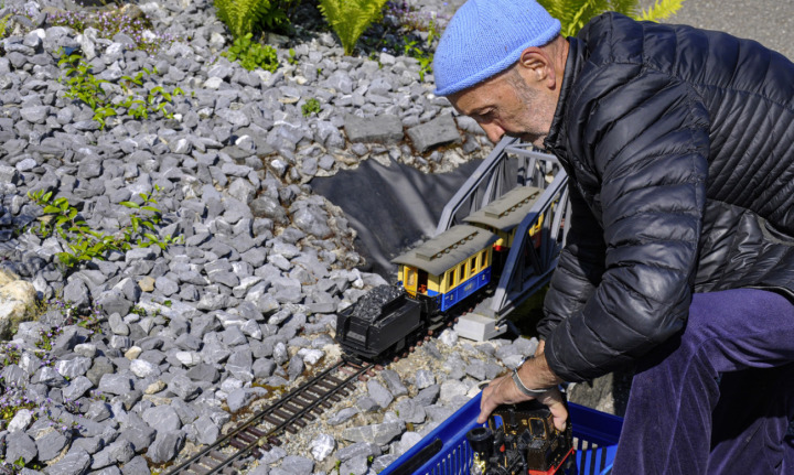 Ueli Nüesch stellt die kleinen Waggons und die Lokomotive auf die Schienen. Fotos: Andreas von Bergen